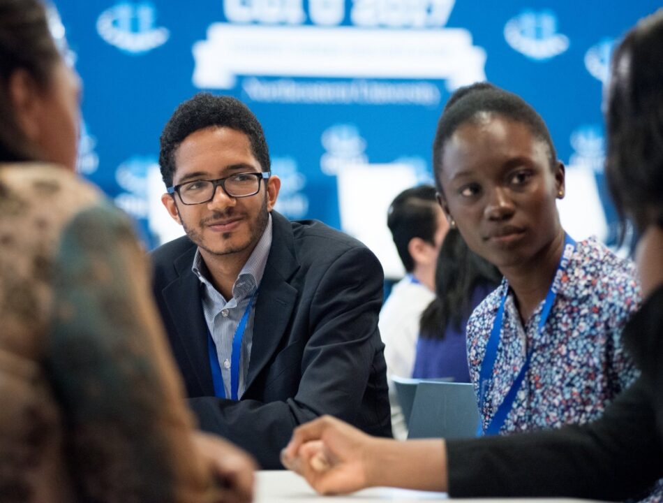 Two individuals participate in a discussion during a CGI U event