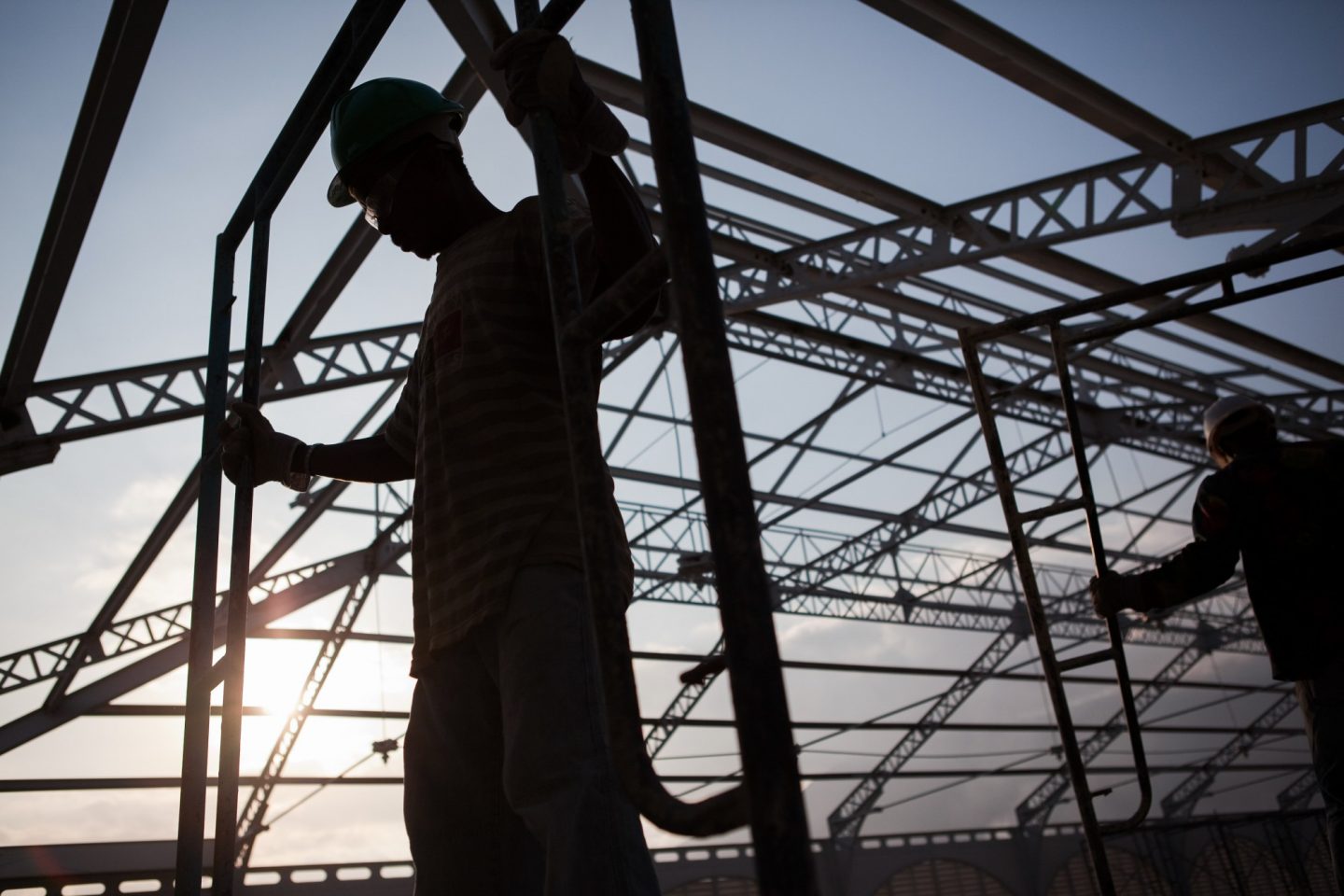 An individual in a hard hat stands in a construction site