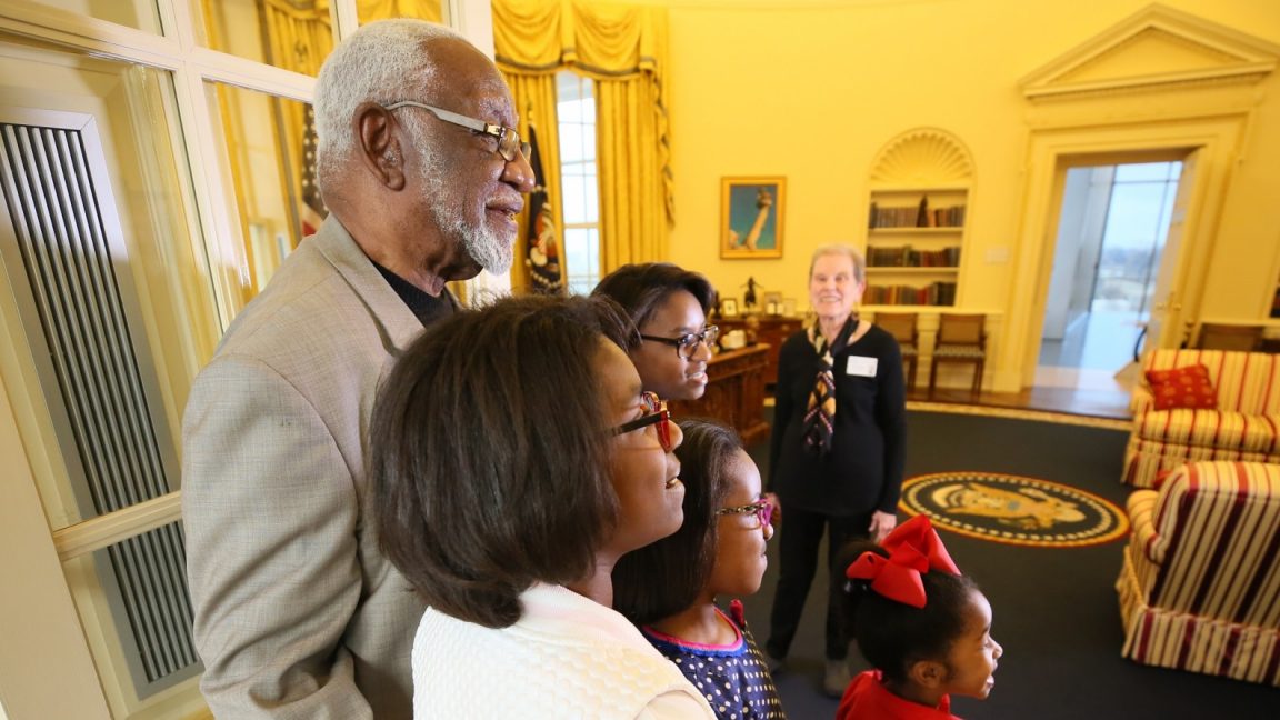 A family looks at a full-scale replica of the Oval Office at the Clinton Presidential Library