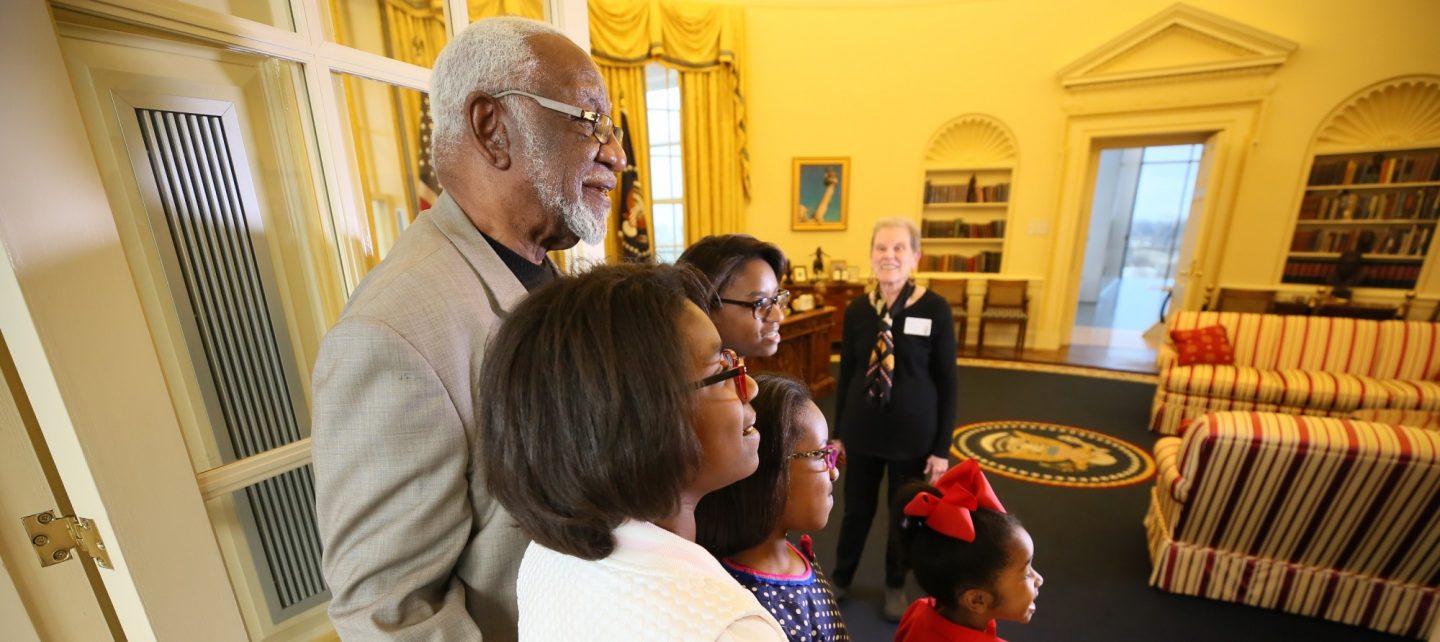 A family looks at a full-scale replica of the Oval Office at the Clinton Presidential Library