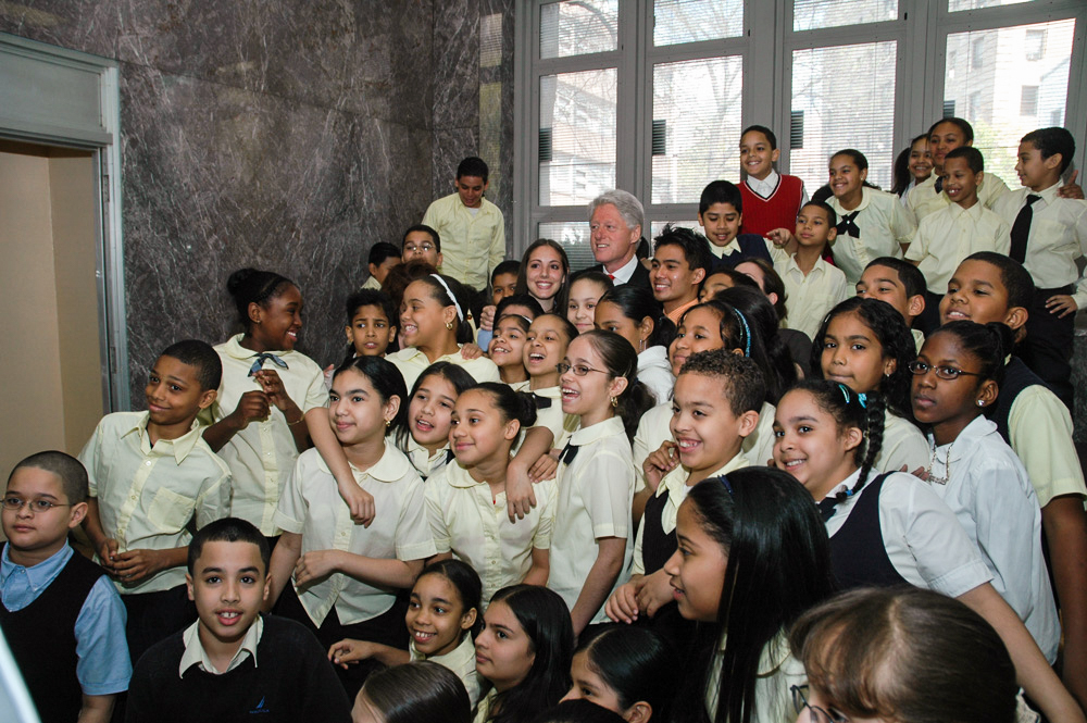 President Clinton stands amid a group of students