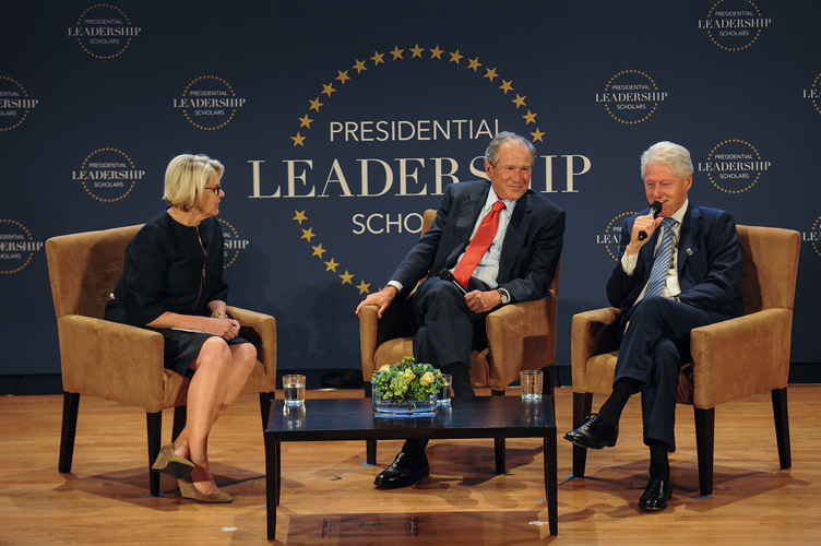 Margaret Spellings, President George W. Bush and President Bill Clinton seated onstage during event