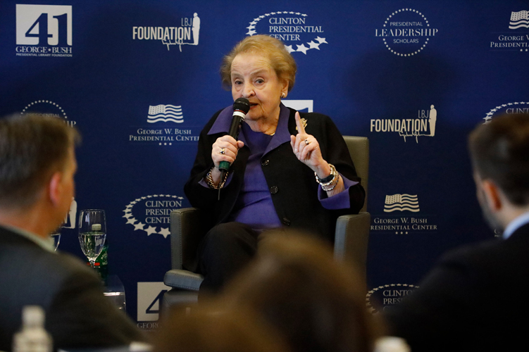 Madeleine Albright speaks into a microphone