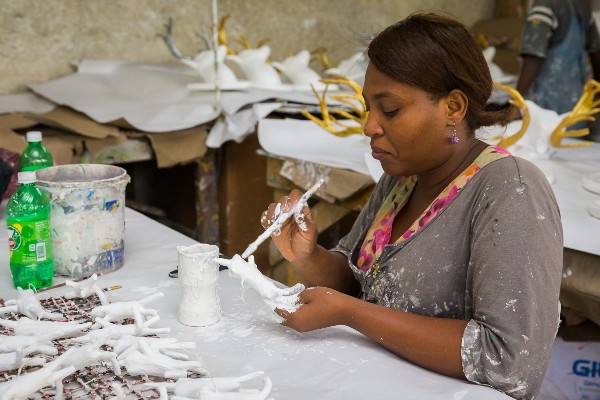 An individual paints artisanal pieces