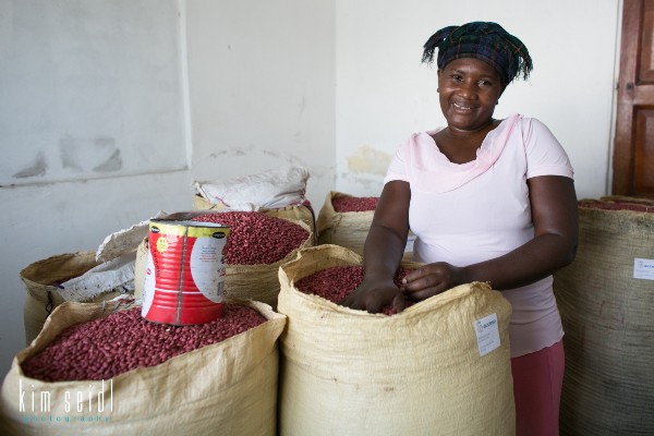 An individual stands with bags filled with peanuts