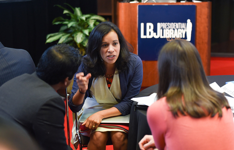 Three individuals converse at the LBJ Library