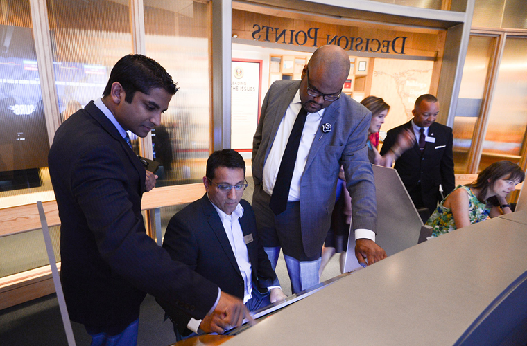 Several individuals use touch screens