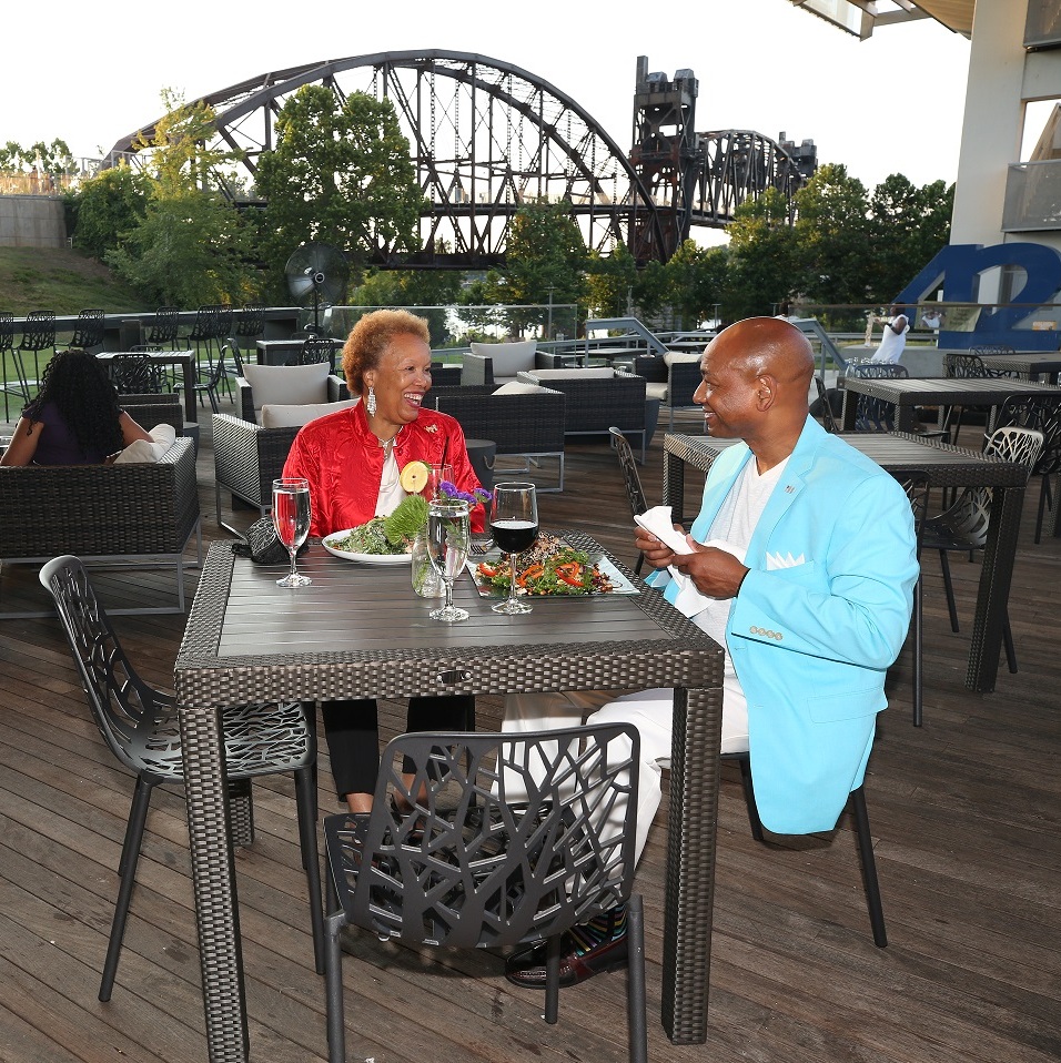 Two individuals dine outdoors on the patio at 42 Bar and Table
