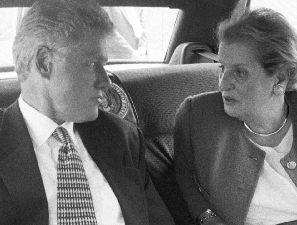 President Clinton and Secretary Madeleine Albright speak while seated in a car