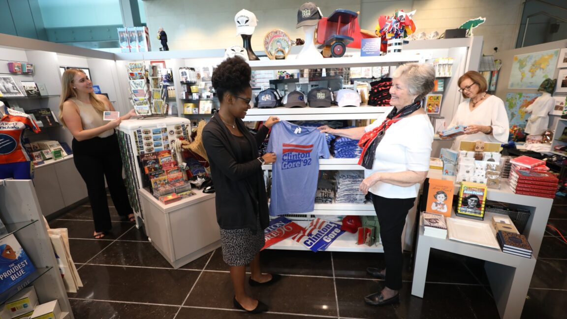 Several individuals look at products at Clinton Museum Store