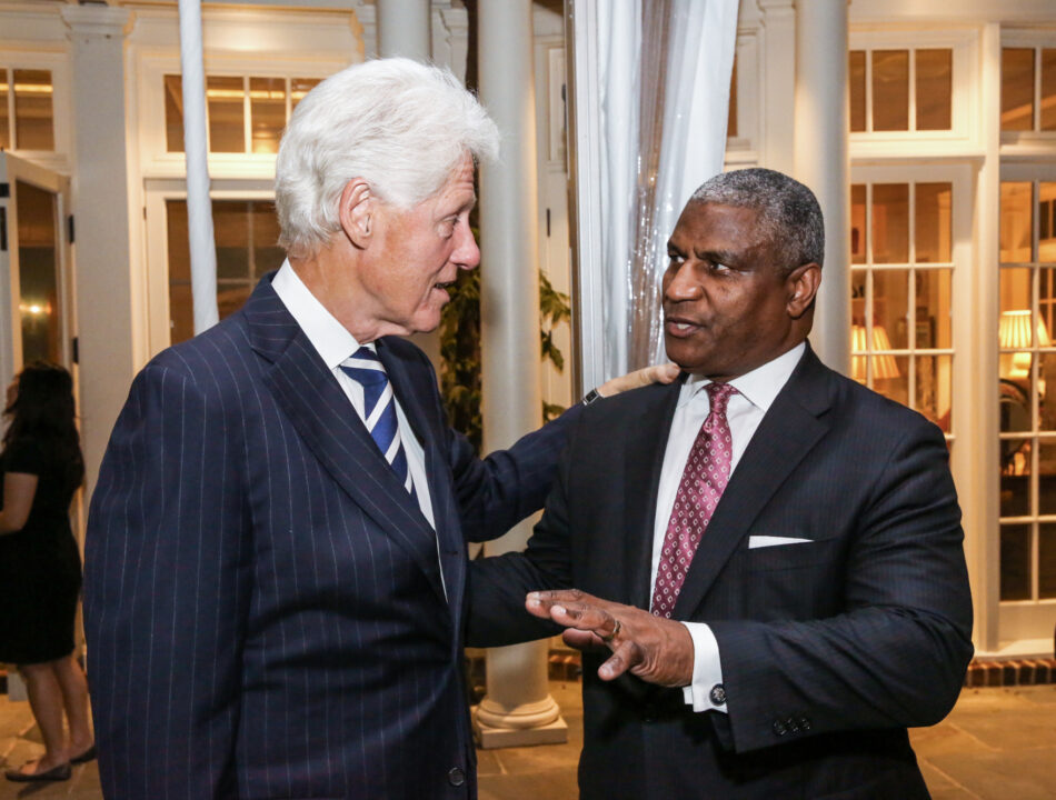 President Clinton and Rodney Slater speak with one another