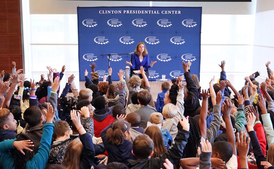 A staff member speaks in front of a group of students