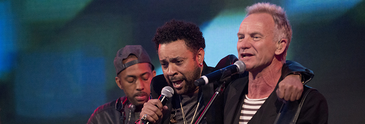 Musicians Sting and Shaggy sing onstage