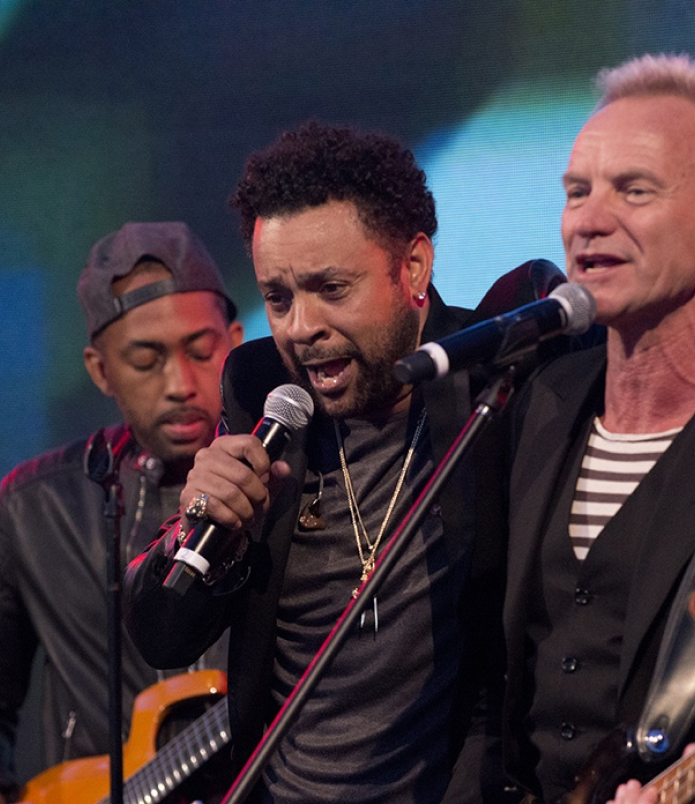 Musicians Sting and Shaggy sing onstage together