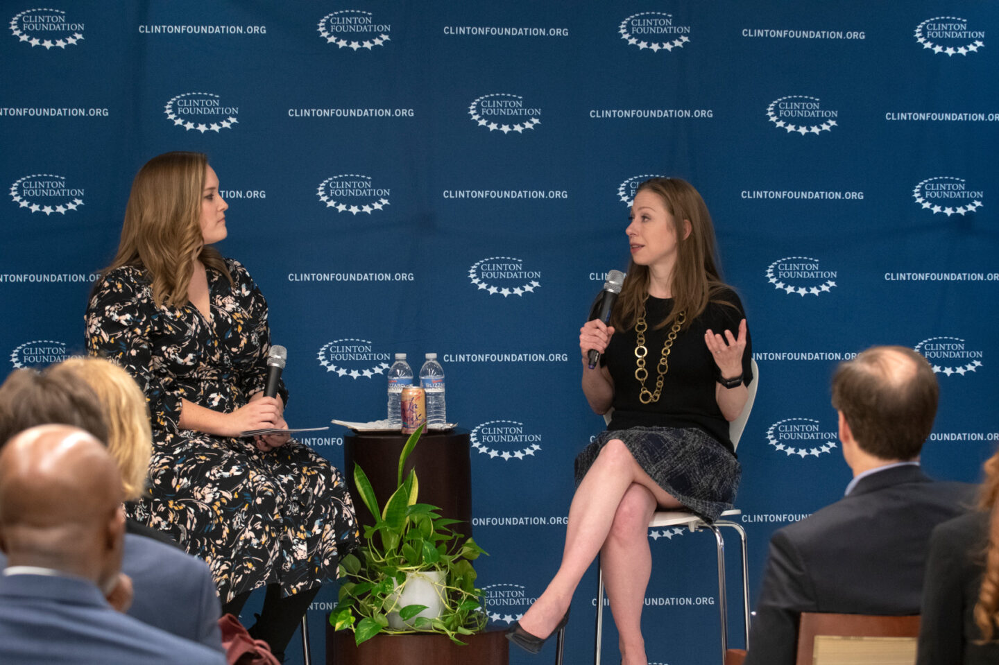 Chelsea Clinton and a staff member speak in front of a group