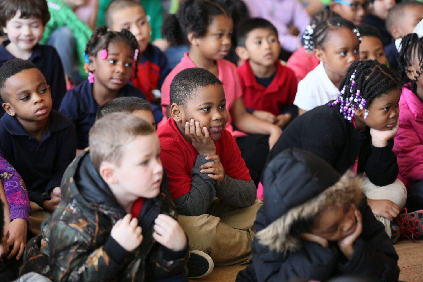 Close-up of group of elementary students seated during event