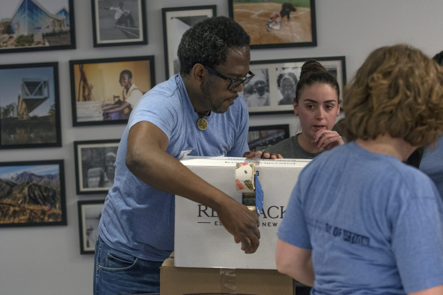 Staff members pack boxes