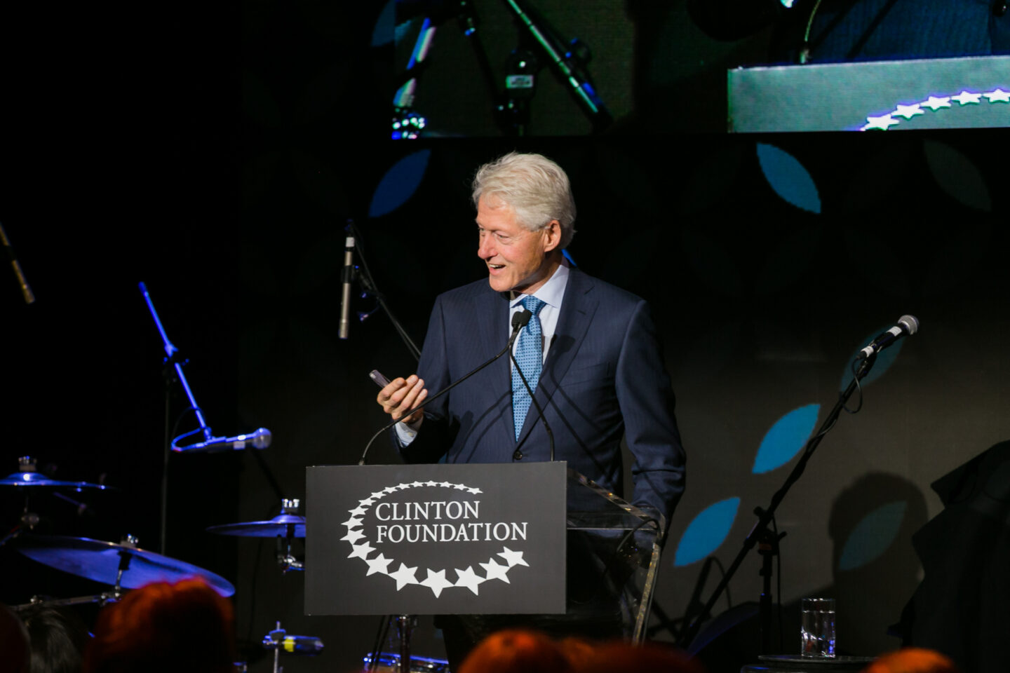 President Clinton speaks at lectern.