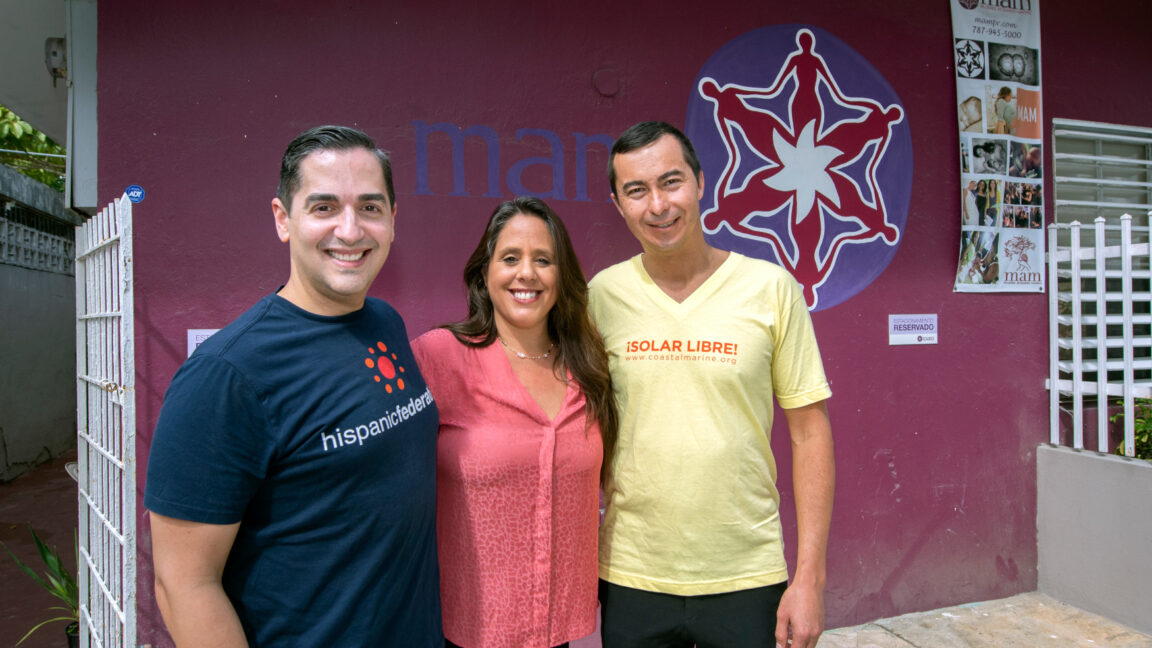 Three individuals stand outside a Centro MAM building