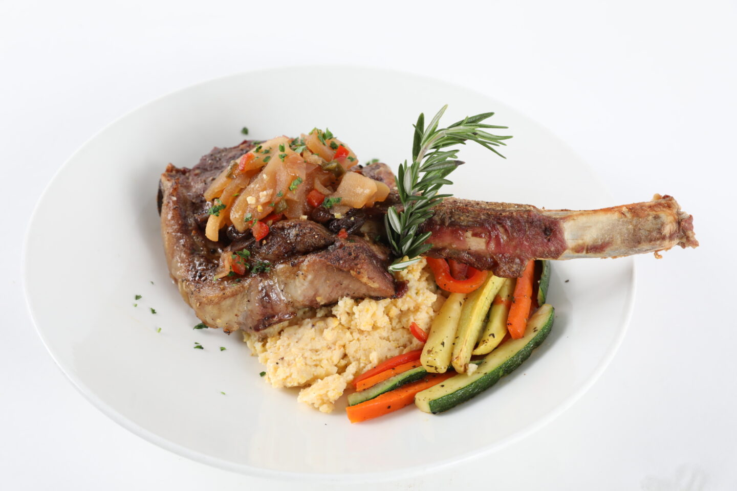 Plated meal which includes pork chops