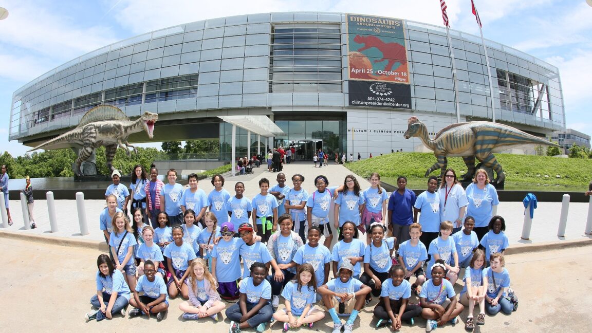 A class of student visitors in front of the Clinton Presidential Center