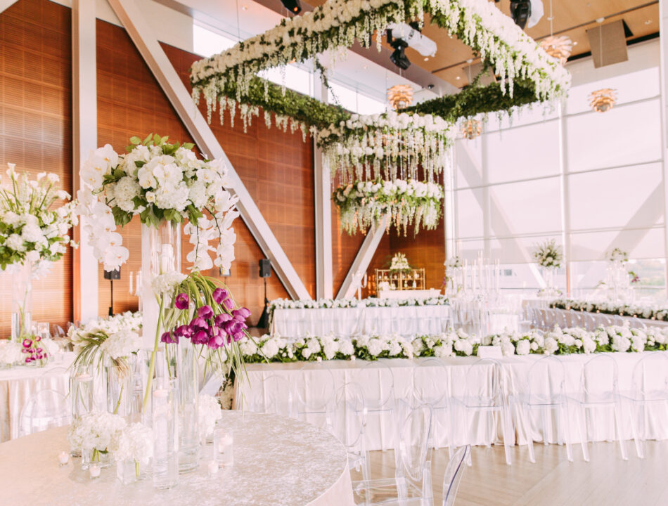 The Clinton Center Great Hall set up for a wedding with floral and table arrangements