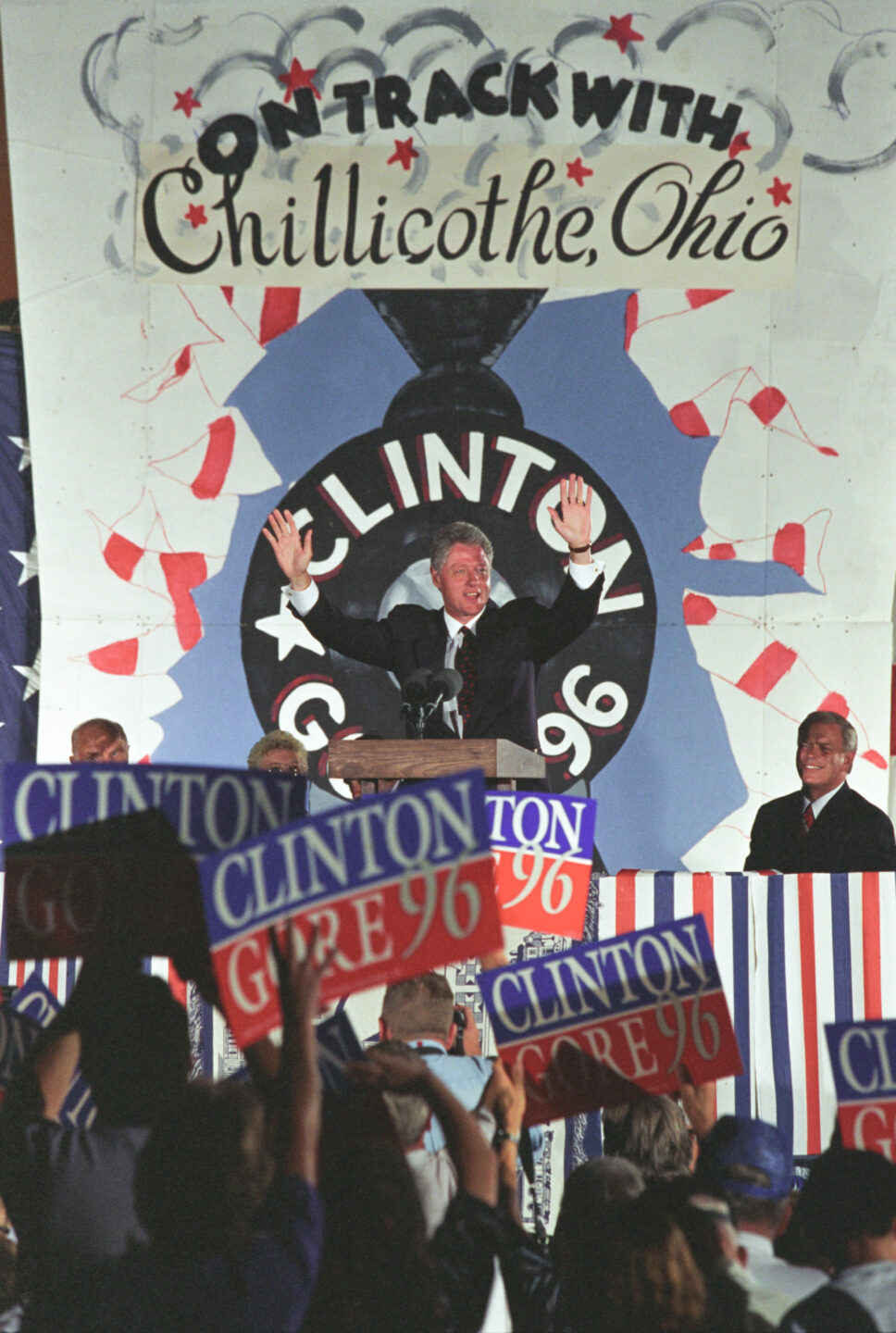 President Bill Clinton speaks on stage.