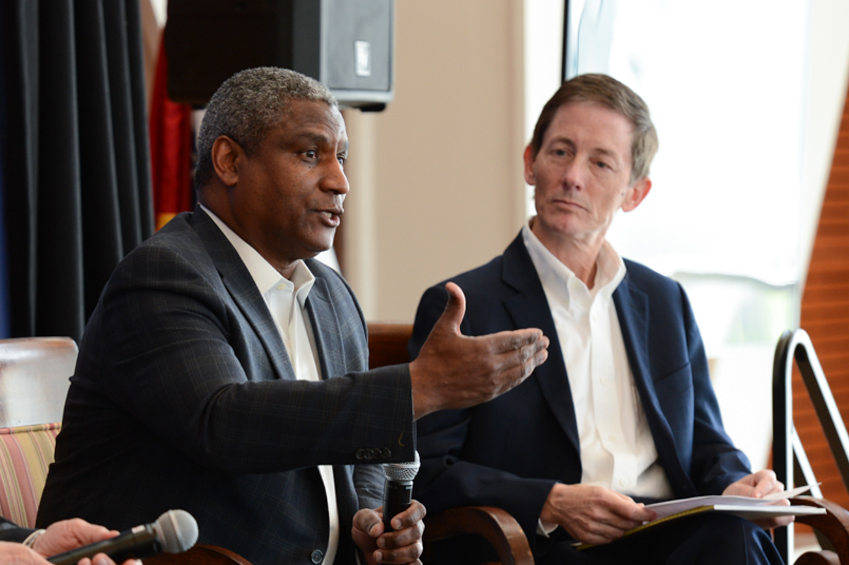 Secretary Rodney Slater and Bruce Reed speak on stage.