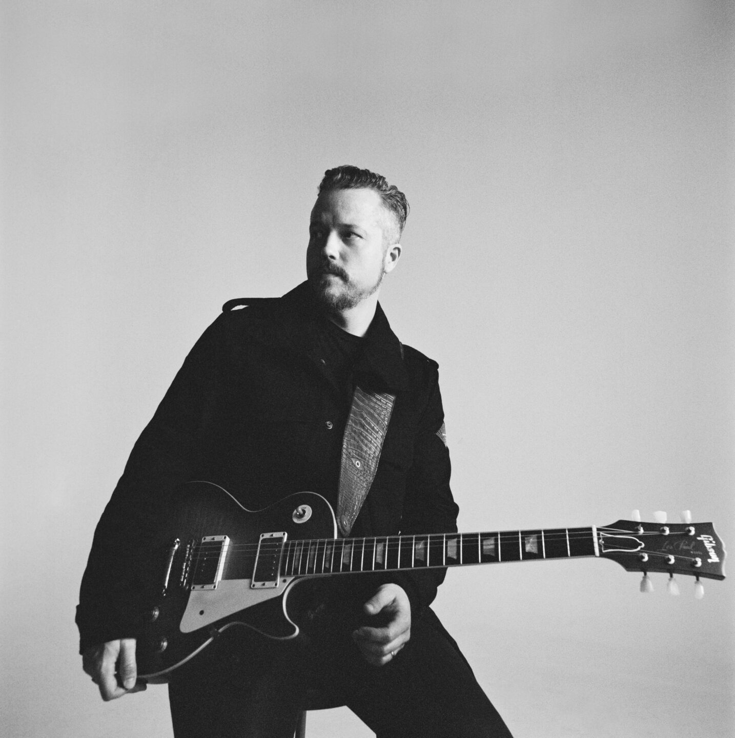 Musician Jason Isbell holding a guitar