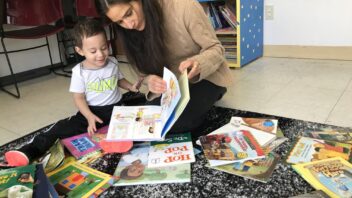 Woman reads with infant