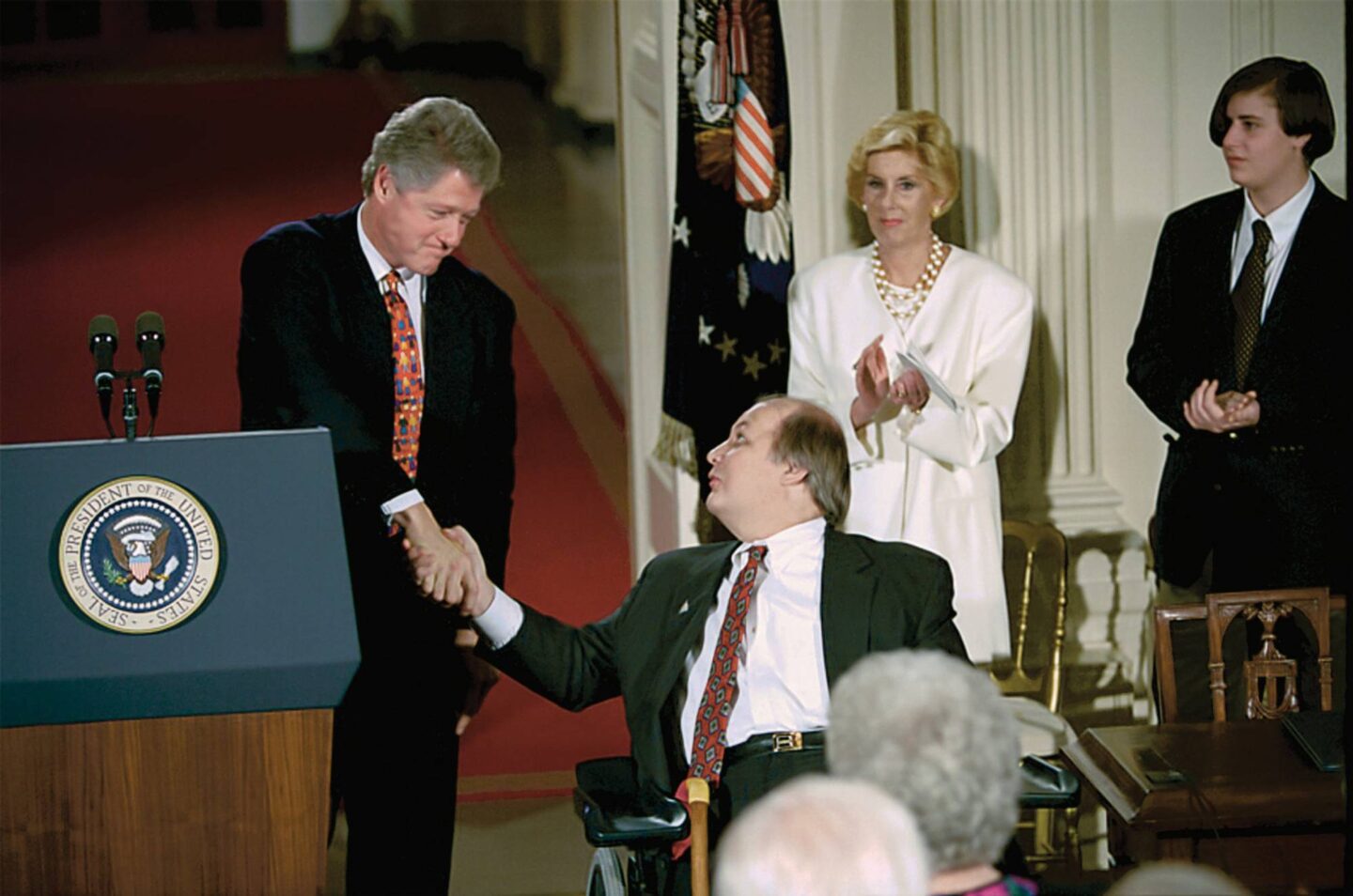 President Clinton and Jim Brady shake hands at the Brady Bill signing ceremony at the White House