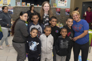 Chelsea Clinton poses with a group of adults and children