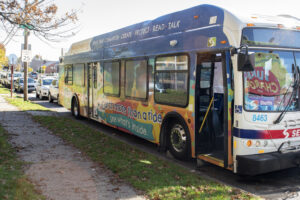 A bus is adorned with colorful illustrations and messages about early language learning
