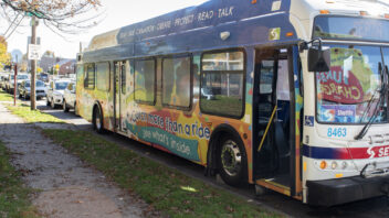 A bus is adorned with colorful illustrations and messages about early language learning