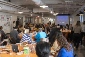 A large group of people are seated in a room
