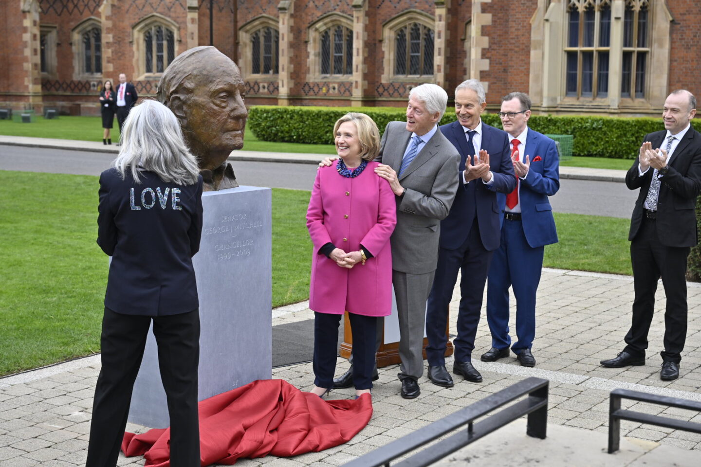 President Clinton and Secretary Clinton stand outside during the unveiling of a bust of Senator George Mitchell