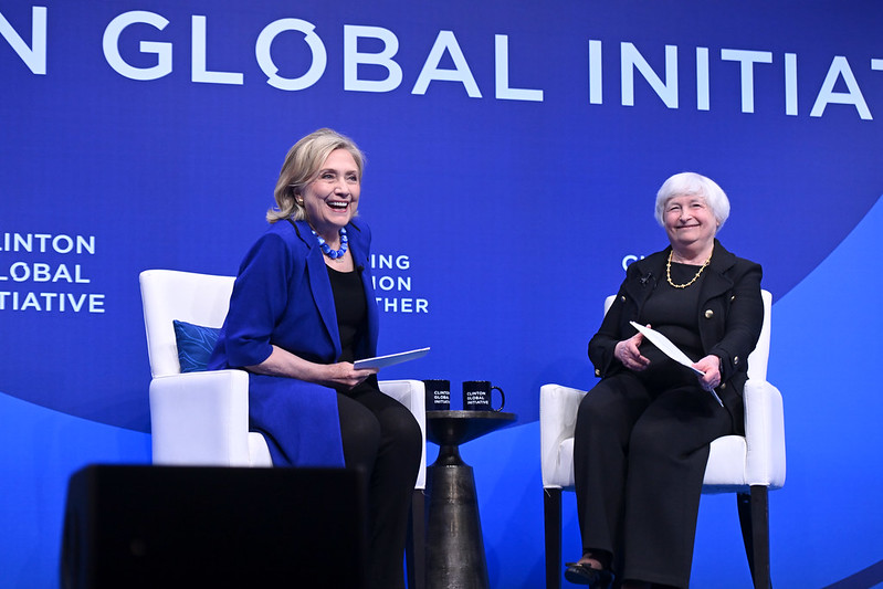 A picture of Secretary Hillary Clinton and Secretary of the Treasury Janet Yellen sitting in two chairs on stage at the Clinton Global Initiative 2023 Meeting.
