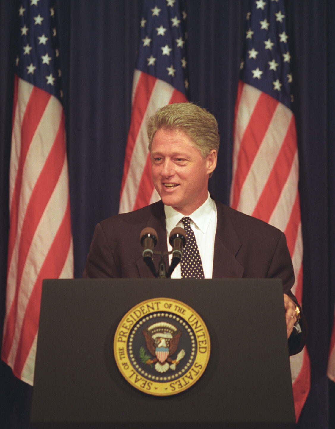 President Bill Clinton speaking at podium