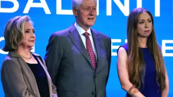 Former Secretary Hillary Clinton, Former President Bill Clinton, and Chelsea Clinton stand side by side onstage at the Clinton Global Initiative 2023 Meeting