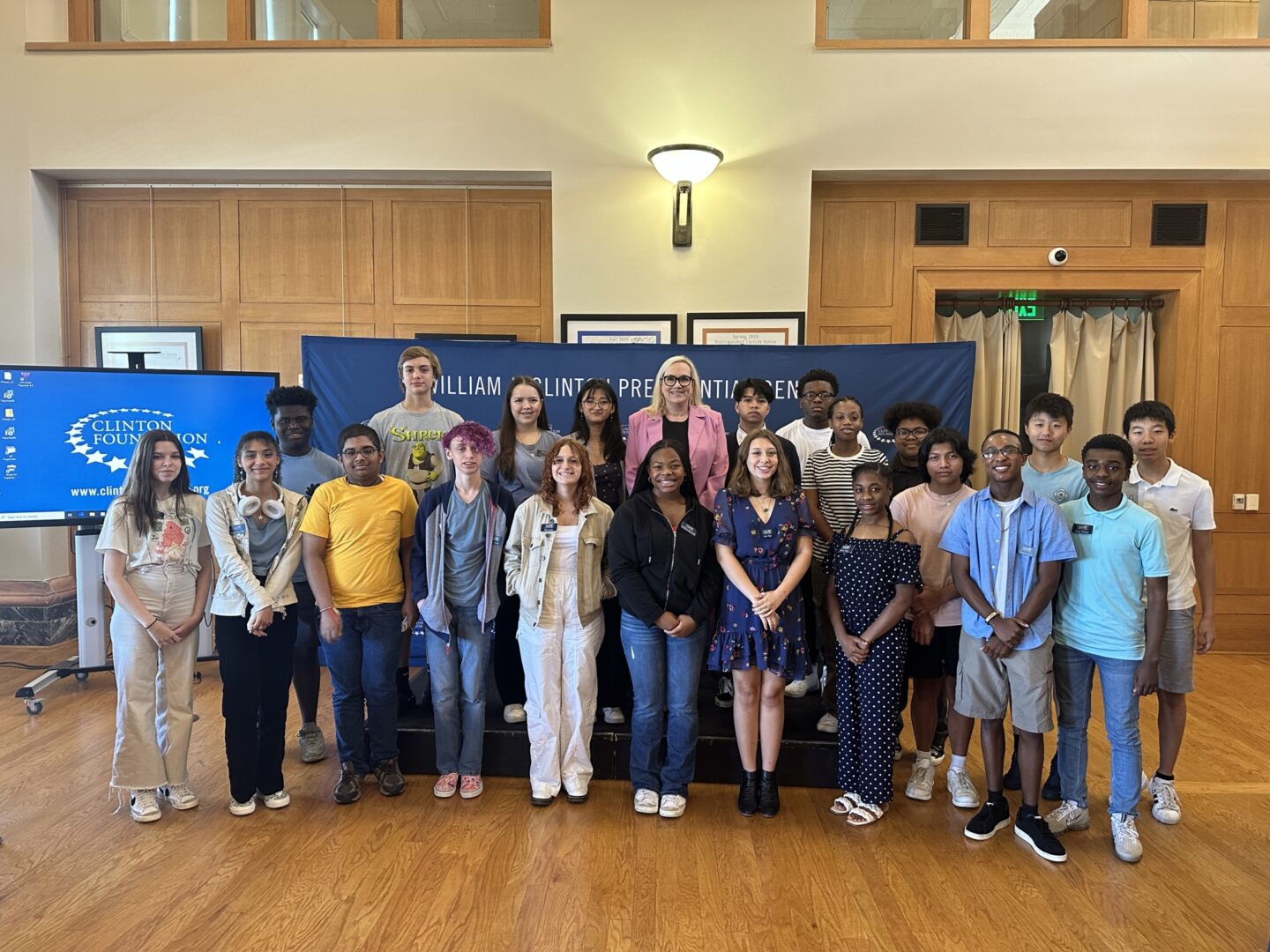 Executive Director, Stephanie Streett and a group of high school students gathered for a photo after an event in Sturgis Hall