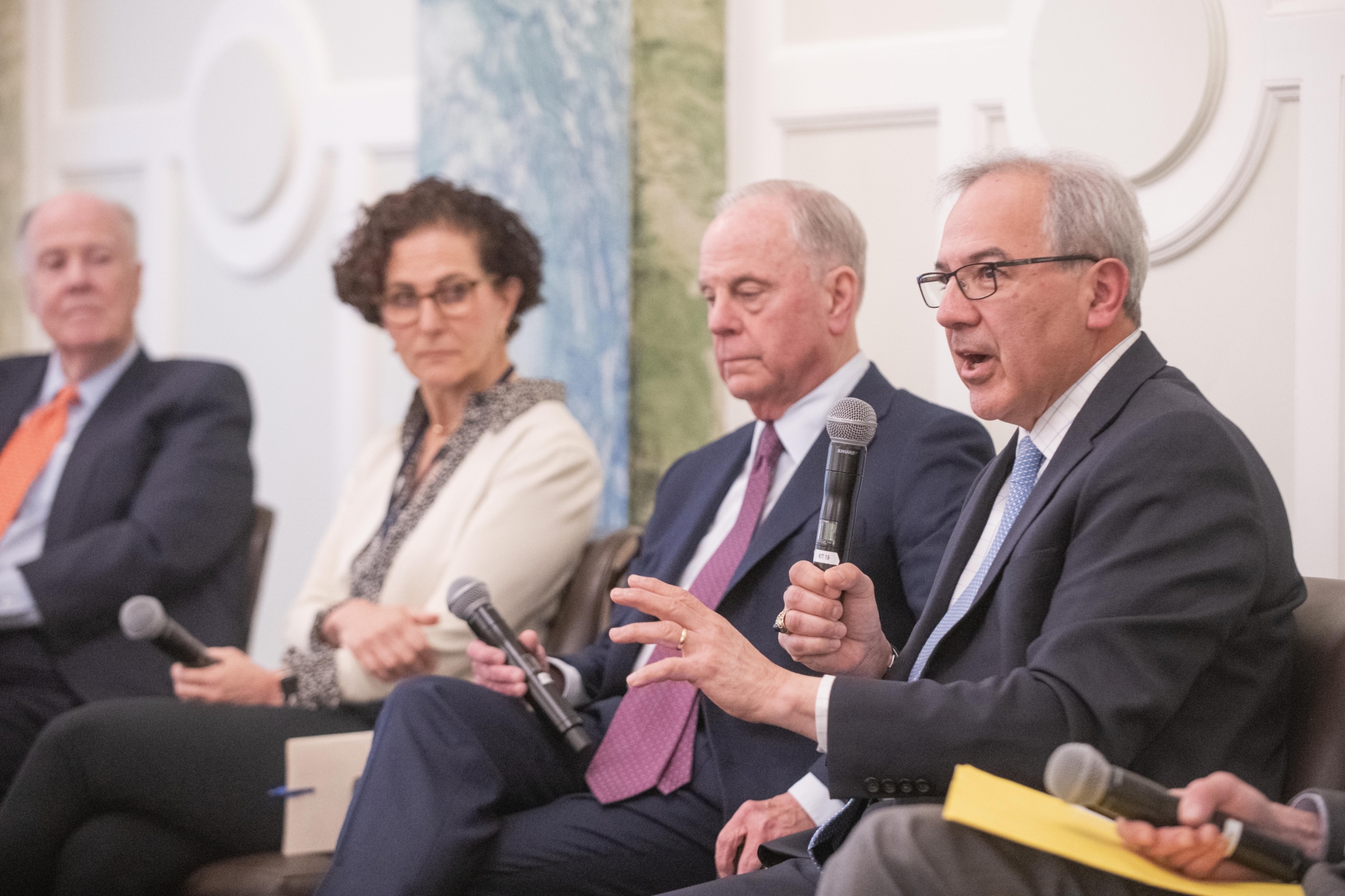 Close up of four panelists sitting on stage.