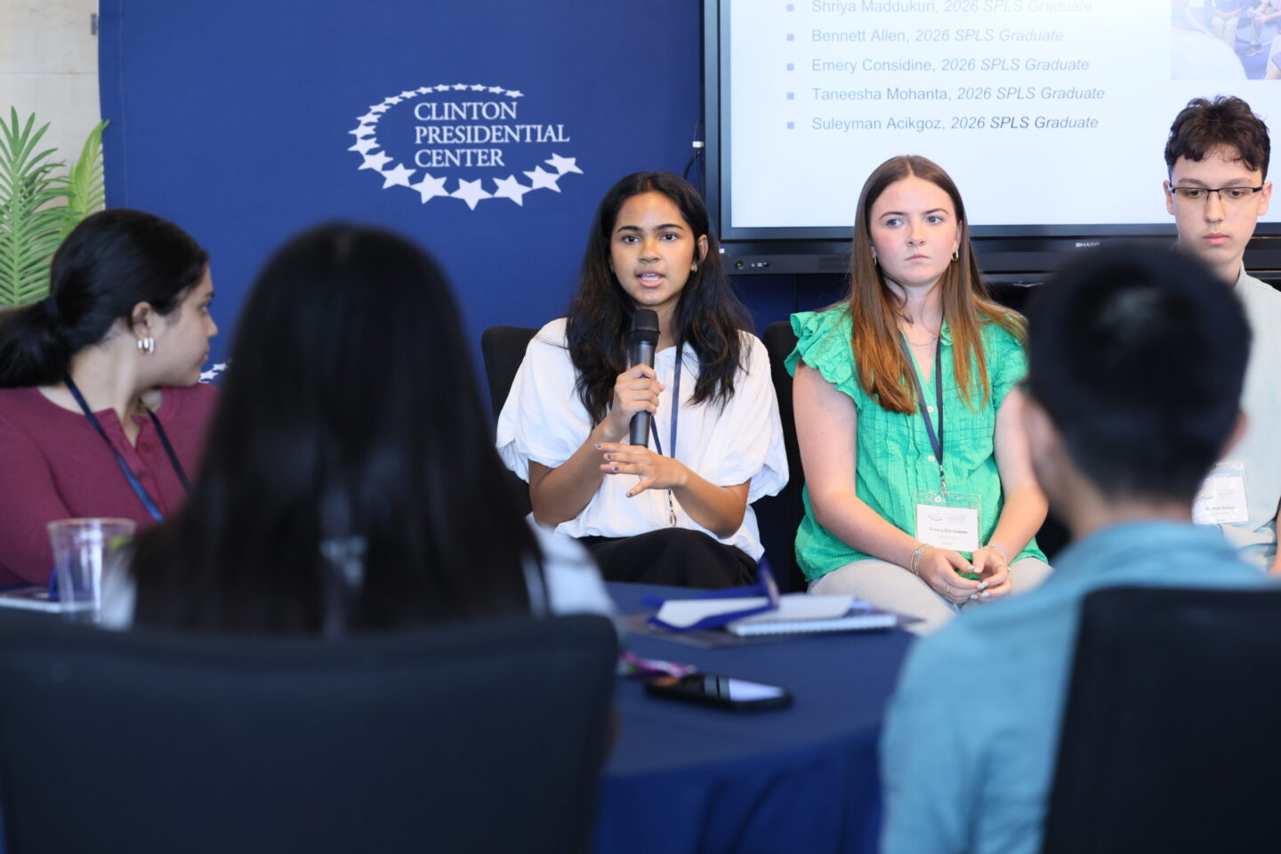 High school student holding a microphone at the Clinton Center