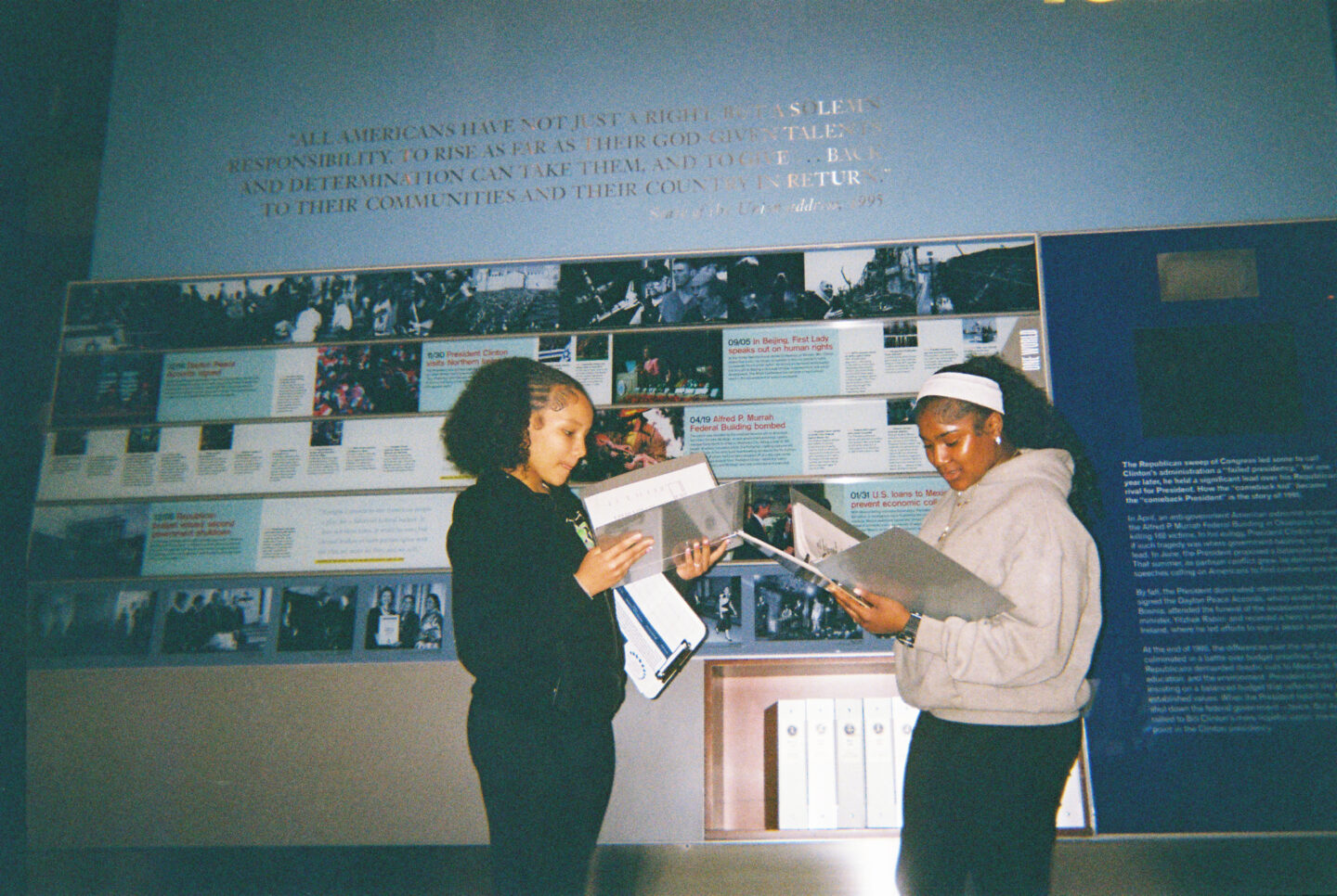 Two students at the Clinton Center viewing the daily schedules