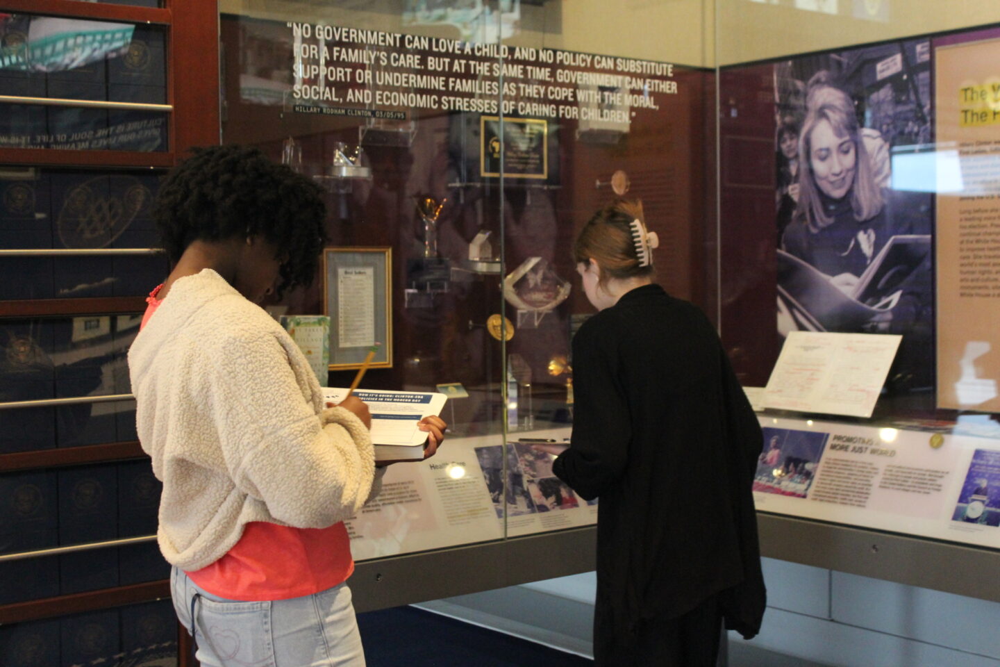 Two students touring The Work of the First Lady alcove in the Clinton Center